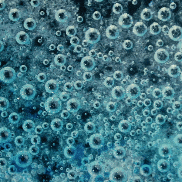 Close-up of numerous bubbles suspended in water or a liquid.