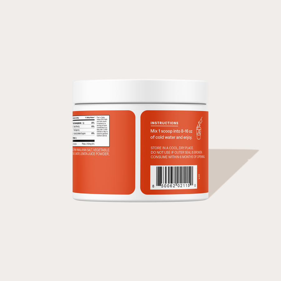 Back view of Blood Orange electrolyte mix jar showcasing instructions panel, nutrition facts, and barcode on a pale background