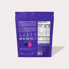 Purple pouch back showing nutrition facts panel, product description text, icons and berry illustrations.