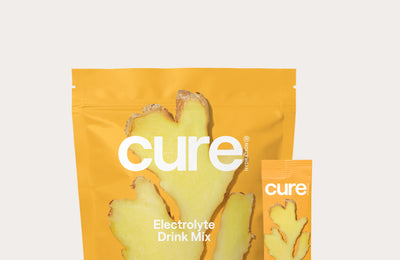Cure Hydration Ginger Turmeric Electrolyte Drink Mix package with ginger root image