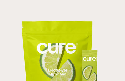 cure Electrolyte Drink Mix Lime pouch and stick packet showing lime slices on bright green packaging