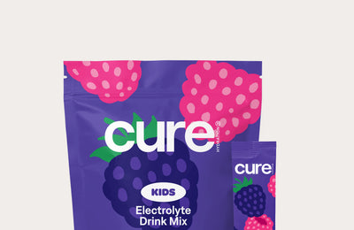 cure KIDS Electrolyte Drink Mix pouch, Mixed Berry flavor, purple packet with berry illustrations
