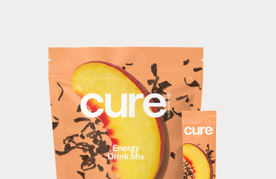 Cure Energy Drink Mix Peach Tea flavor packet and pouch with a peach slice and tea leaves on the packaging