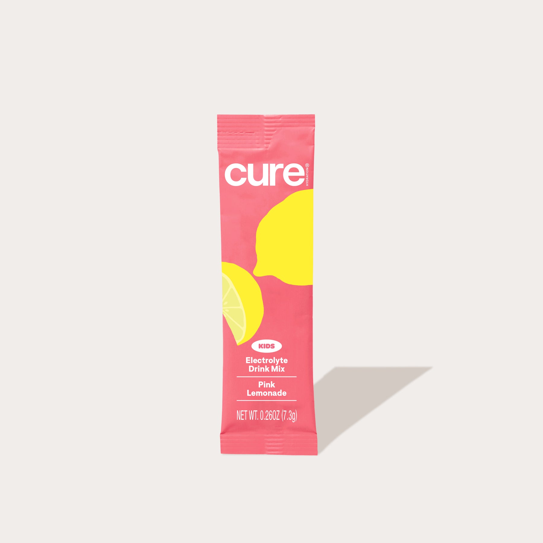 Single-serve pink 'cure' packet with lemon graphics labeled 'Electrolyte Drink Mix' flavor 'Pink Lemonade'.