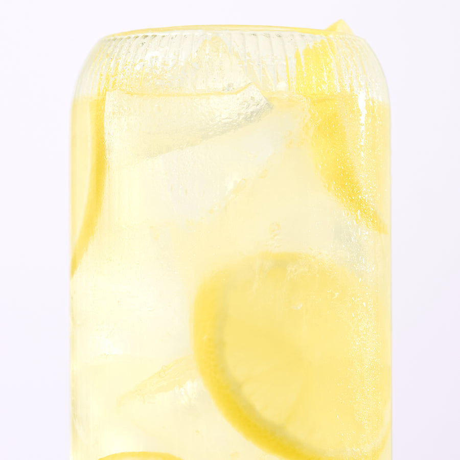 Close-up of Lemonade electrolyte drink showcasing lemon slices and ice in a tall glass on a white background