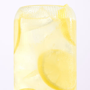 Close-up of Lemonade electrolyte drink showcasing lemon slices and ice in a tall glass on a white background