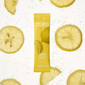 Front view of Lemonade electrolyte stick showing Cure logo and lemon graphics with sliced lemons in fizzy water