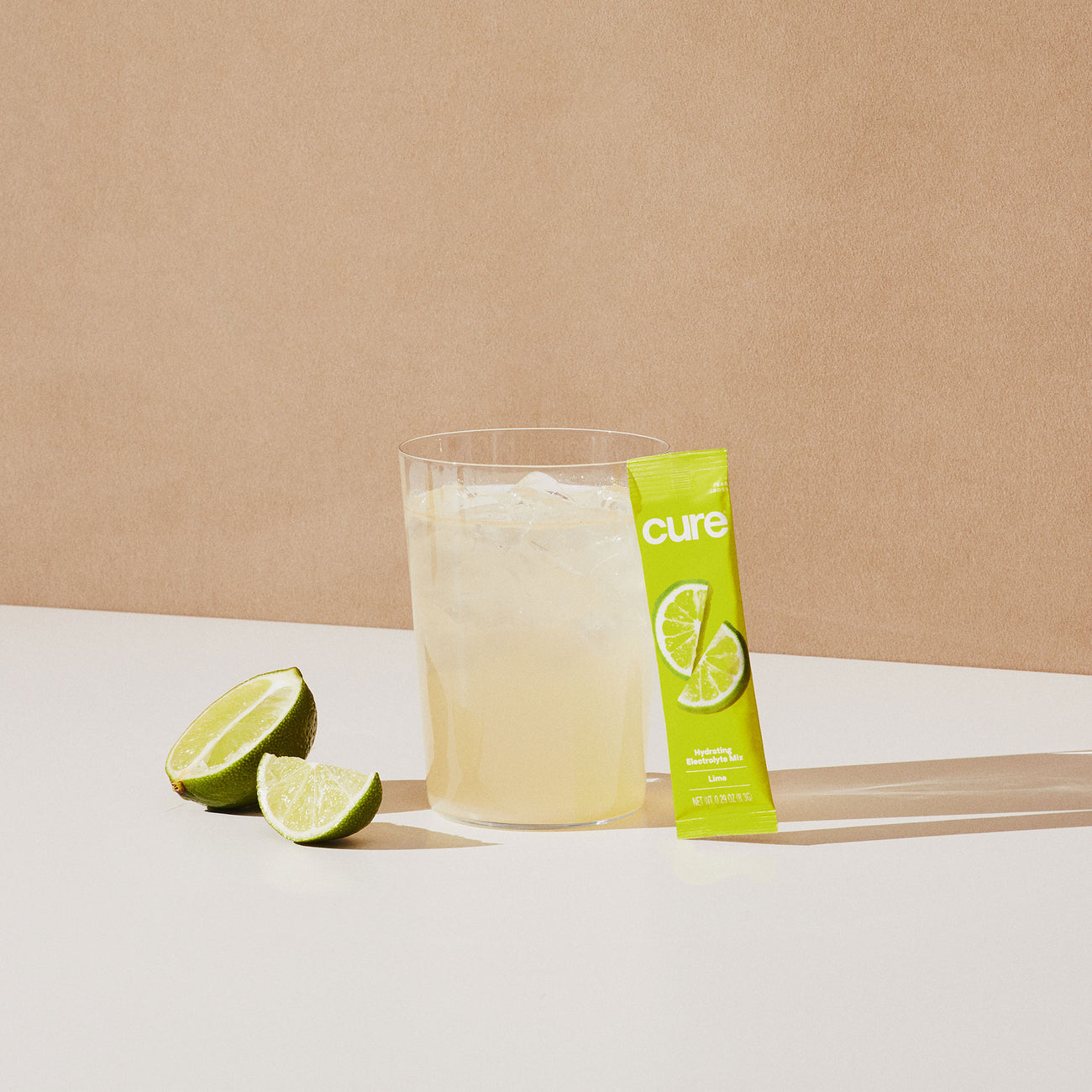 Lime-flavored drink with mix packet and lime slices.