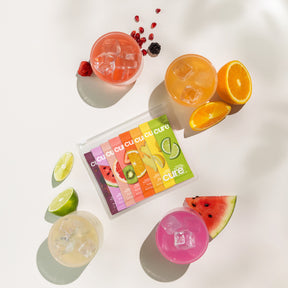 Hydration mix packets with fruits and drinks on a sunny white background.