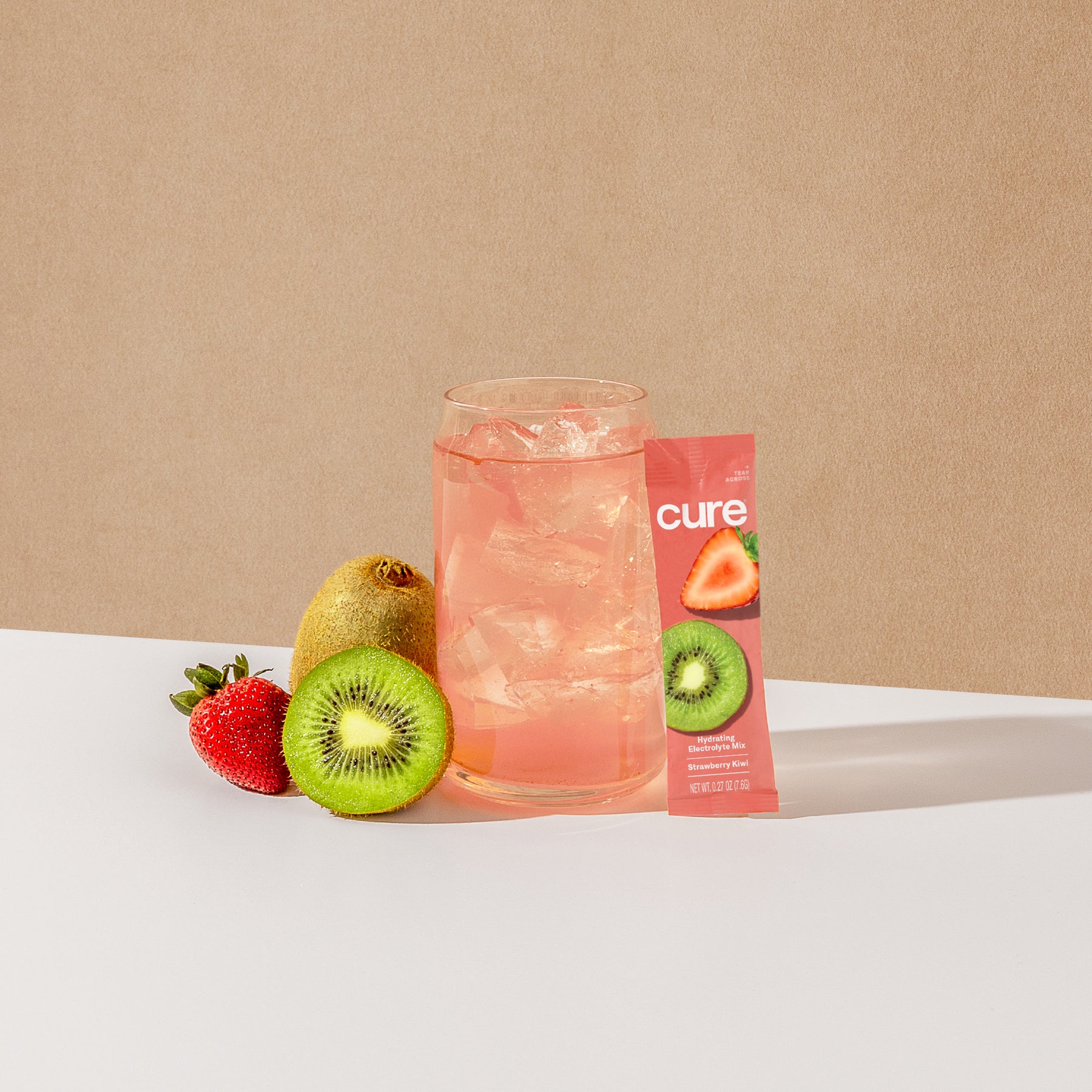 Pink drink with a strawberry kiwi mix packet and fresh fruits.